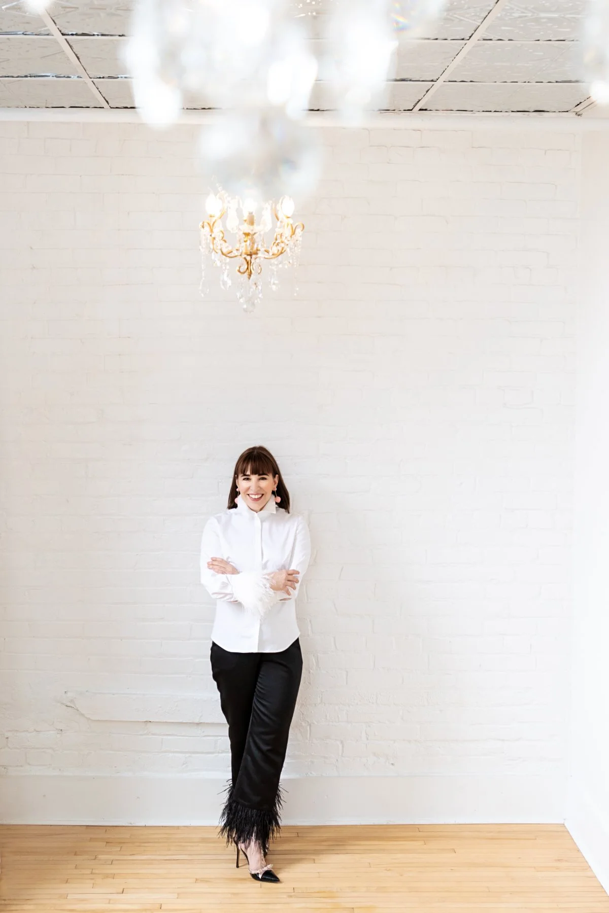 Rachel Williamson standing against a white brick wall