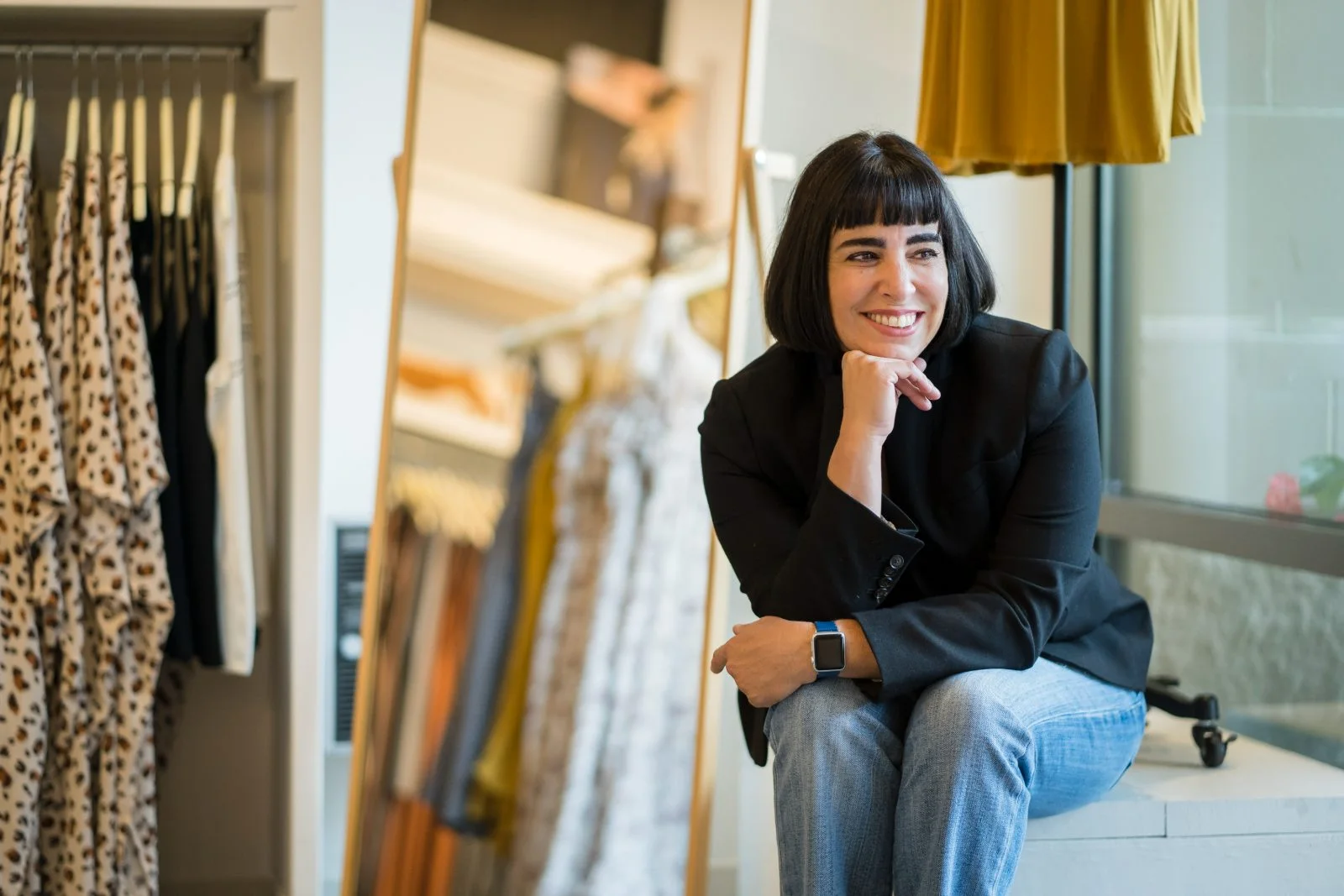Rachel Williamson seated inside a clothing store